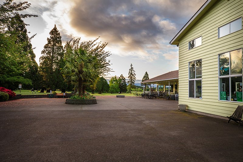 Picnic area and large space of concrete outside the pro shop and golf club